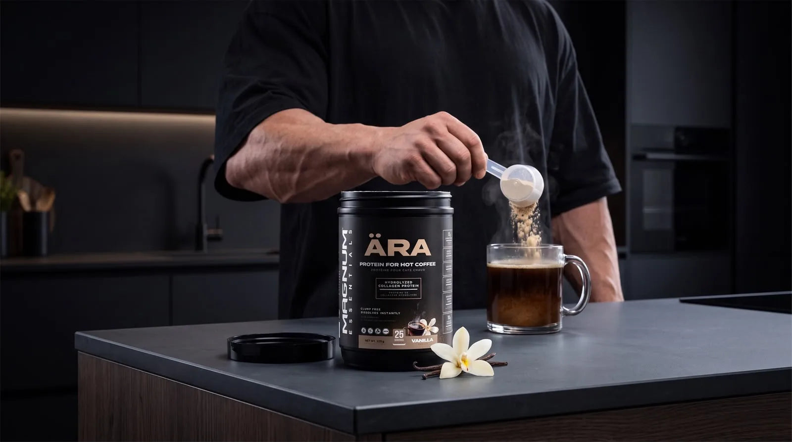 A scoop pouring ÄRA vanilla powder into a steaming glass mug of black coffee beside the ÄRA tub on a dark kitchen counter